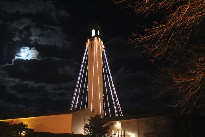 Pilgrim Monument and Provincetown Museum decorated with lights and full moon, December 2013